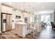 Well-lit kitchen with an island, stainless steel appliances, and open access to the dining area at 3315 Whispering Creek Dr # 95, Wesley Chapel, NC 28079