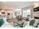 Open-concept living area flowing into the kitchen and dining, featuring wood floors and natural light at 3315 Whispering Creek Dr # 95, Wesley Chapel, NC 28079