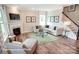 Cozy living room with a fireplace, comfortable seating, and staircase with white railings at 3315 Whispering Creek Dr # 95, Wesley Chapel, NC 28079