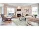 Relaxing living room with a cozy fireplace, large windows, and comfortable seating arrangement at 3315 Whispering Creek Dr # 95, Wesley Chapel, NC 28079