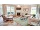 Inviting living room with a fireplace, plush seating, and large windows offering plenty of light at 3315 Whispering Creek Dr # 95, Wesley Chapel, NC 28079