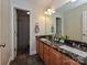 Bathroom features double sinks, a large mirror, tile flooring, and wood cabinets at 3409 Valdosta Ct, Monroe, NC 28110