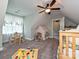Bright bedroom featuring a small bed, toys, a ceiling fan, and a window at 3409 Valdosta Ct, Monroe, NC 28110