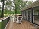 Spacious outdoor deck with dining table and chairs and sliding glass door access to screened porch at 3409 Valdosta Ct, Monroe, NC 28110