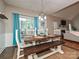 Features a wood dining table with seating for six, bright curtains, and wood floors at 3409 Valdosta Ct, Monroe, NC 28110