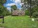 Charming two-story brick home with a well-manicured lawn, surrounded by mature trees at 3409 Valdosta Ct, Monroe, NC 28110