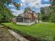 Rear exterior view of the home featuring a screened-in porch, deck and creek at 3409 Valdosta Ct, Monroe, NC 28110
