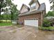 Rear exterior featuring the garage and access to the back yard and deck at 3409 Valdosta Ct, Monroe, NC 28110