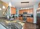 Features gorgeous granite countertops, stainless appliances, tiled backsplash, and pendant lighting at 3409 Valdosta Ct, Monroe, NC 28110