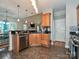 Features stainless dishwasher, granite countertops, wood cabinets, and tiled floors at 3409 Valdosta Ct, Monroe, NC 28110