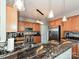 Features a gorgeous granite countertop, stainless steel appliances, tile backsplash, and pendant lighting at 3409 Valdosta Ct, Monroe, NC 28110