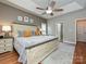 Shows the spacious main bedroom, with a king bed, ceiling fan, and natural light from windows at 3409 Valdosta Ct, Monroe, NC 28110