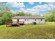 A backyard with a wooden deck, grassy lawn, and mature trees at 3716 Hamilton Dr, Gastonia, NC 28052