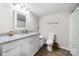 Bathroom featuring a white vanity with granite countertop, a mirror, and wood look flooring at 3716 Hamilton Dr, Gastonia, NC 28052