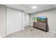 Spare bedroom with large wardrobe, door, window, dresser, and mounted tv at 3716 Hamilton Dr, Gastonia, NC 28052