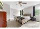 Comfortable bedroom with a wrought iron bed, ceiling fan, and natural light at 3716 Hamilton Dr, Gastonia, NC 28052