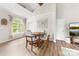 Cozy dining area with a round wooden table, seating for four, and arched window overlooking a lush yard at 3716 Hamilton Dr, Gastonia, NC 28052