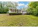 Ranch-style home features a charming porch and expansive front yard with mature trees at 3716 Hamilton Dr, Gastonia, NC 28052