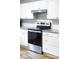 Close-up of a stainless steel oven with white cabinets and granite countertops in the kitchen at 3716 Hamilton Dr, Gastonia, NC 28052