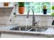 Close-up of a stainless steel kitchen sink with a modern faucet and a window view at 3716 Hamilton Dr, Gastonia, NC 28052