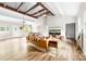 Bright living room features vaulted ceilings with wooden beams and neutral colored walls and furnishings at 3716 Hamilton Dr, Gastonia, NC 28052