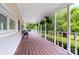Spacious porch with wooden flooring, white railings, and hanging ferns at 3716 Hamilton Dr, Gastonia, NC 28052