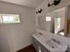 This renovated bathroom features double sinks, modern lighting and beautiful nature views at 401 Constant Ln, Charlotte, NC 28722