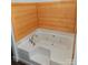 Corner bathtub with jets and wood paneling at 401 Constant Ln, Charlotte, NC 28722