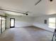 Unfinished garage with a window and a door to the outside at 401 Constant Ln, Charlotte, NC 28722