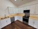 Kitchen showcasing white cabinets, stainless steel appliances, and butcher block countertops at 401 Constant Ln, Charlotte, NC 28722