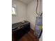 Modern laundry room with front loading Samsung washer and dryer and AoSmith water heater at 401 Constant Ln, Charlotte, NC 28722