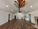 Bright living room featuring hardwood floors, modern kitchen, and unique ceiling fan at 401 Constant Ln, Charlotte, NC 28722