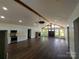 Open-concept living room featuring hardwood floors, fireplace, and beamed vaulted ceiling at 401 Constant Ln, Charlotte, NC 28722