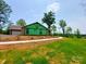 New construction home featuring a large garage and green yard at 401 Constant Ln, Charlotte, NC 28722