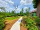 Landscaped side of new construction home with a concrete walkway at 401 Constant Ln, Charlotte, NC 28722