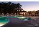 Inviting community pool and lounge area illuminated at dusk, perfect for relaxing evenings at 4044 Murray St, Indian Land, SC 29707
