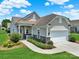 Well-maintained home exterior featuring stone accents, a manicured lawn, and a welcoming walkway at 4044 Murray St, Indian Land, SC 29707