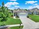 Inviting home featuring a two-car garage, lush lawn, stone accents, and a charming front porch at 4044 Murray St, Indian Land, SC 29707