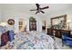 Stylish main bedroom featuring floral bedding, a wooden dresser, and a glimpse into the en suite bathroom at 4044 Murray St, Indian Land, SC 29707