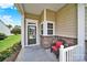 Inviting porch with decorative chair, stone accents, and convenient access to the front door at 4044 Murray St, Indian Land, SC 29707