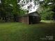 View of the backyard and the exterior of the brick house at 409 Anne Ave, Waxhaw, NC 28173