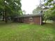 View of the backyard and the exterior of the brick house at 409 Anne Ave, Waxhaw, NC 28173