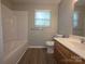 Well lit bathroom featuring a tub and shower combination, and a single sink vanity at 409 Anne Ave, Waxhaw, NC 28173