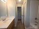 Bathroom with a single sink vanity, toilet, and shower/tub combo at 409 Anne Ave, Waxhaw, NC 28173
