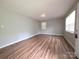 Freshly painted bedroom features clean, plank flooring and bright sunlight from multiple windows at 409 Anne Ave, Waxhaw, NC 28173