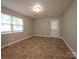 Open living area with neutral paint, lots of natural light, and clean plank flooring at 409 Anne Ave, Waxhaw, NC 28173