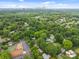 Captured from above, a vibrant neighborhood with lush greenery and a city skyline in the distance at 4106 Castlewood Rd, Charlotte, NC 28209