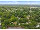 An aerial view shows a lush, green neighborhood with mature trees and a mix of residential homes at 4106 Castlewood Rd, Charlotte, NC 28209