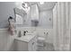 Charming bathroom featuring patterned tile floor, wainscoting, marble countertop, and shower with curtain at 4106 Castlewood Rd, Charlotte, NC 28209