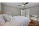 View of a comfortable bedroom with hardwood floors, a ceiling fan, and a double door closet at 4106 Castlewood Rd, Charlotte, NC 28209